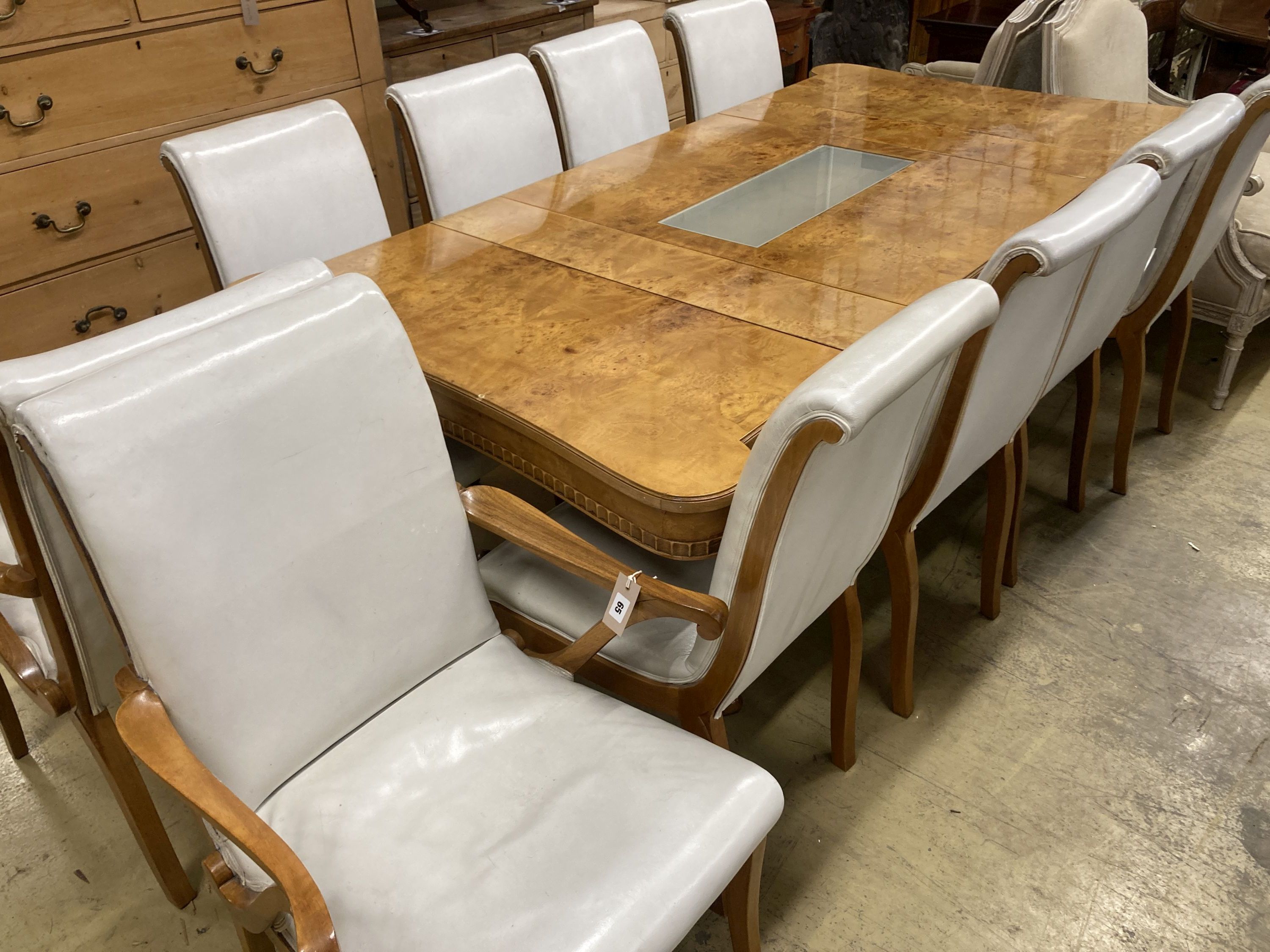 A mid century birds eye maple and walnut dining suite, comprising extending table, 205cm, depth 106cm, height 76cm, a set of ten dining